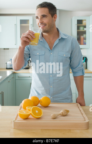Man drinking orange juice Stock Photo