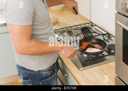 Man cooking fried breakfast Stock Photo