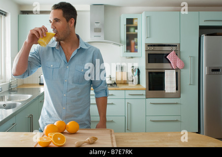 Man drinking orange juice Stock Photo