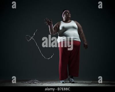 Overweight woman throwing measuring tape Stock Photo