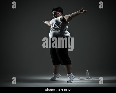 Overweight woman exercising Stock Photo