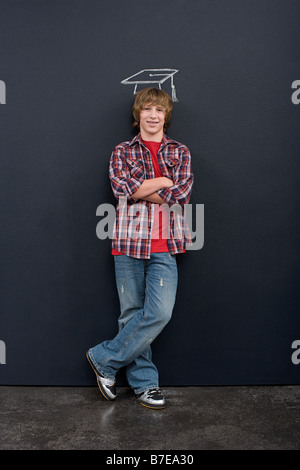 A boy with a chalk mortar board Stock Photo