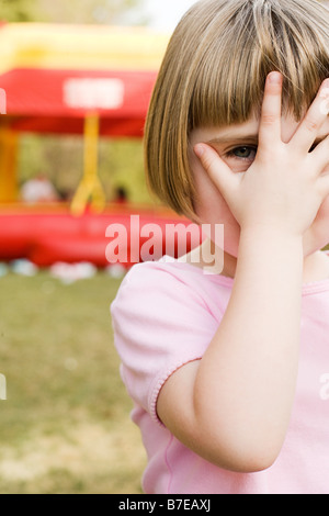 Girl with hand in front of face Stock Photo