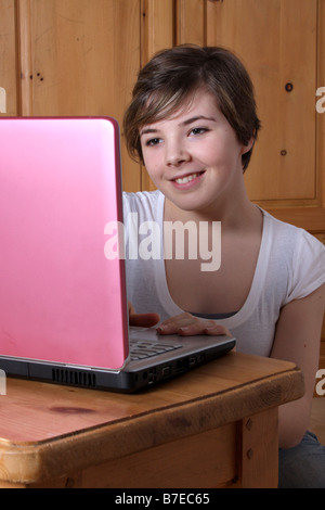 A 14 year old girl working on her home PC Stock Photo