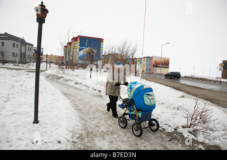 Woman walking with baby carriage, Anadyr Chukotka Siberia Russia Stock Photo