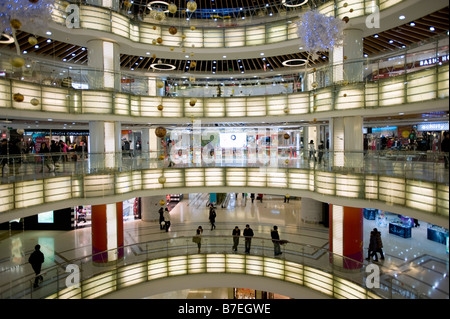 Interior of large new modern shopping mall called Joy City in Xidan district Beijing 2009 Stock Photo