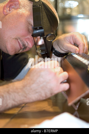 a craftsman building a replica of a battle ship focus is on his face Stock Photo