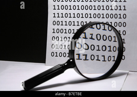 Magnifying glass on binary background Stock Photo