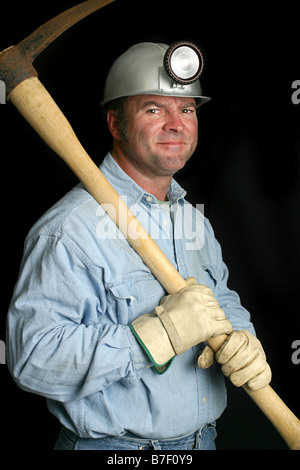 A friendly coal miner with his pick ax over his shoulder Stock Photo