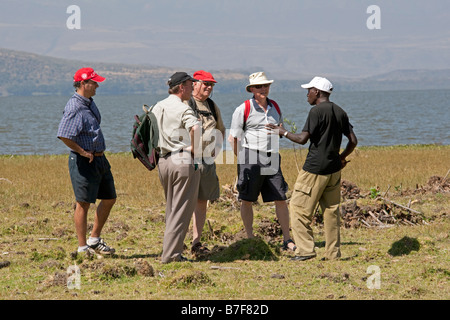 Group of tourists walking with wildlife ranger Crescent Island Lake Naivasha Kenya Stock Photo