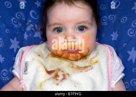 A messy baby girl during meal time Stock Photo