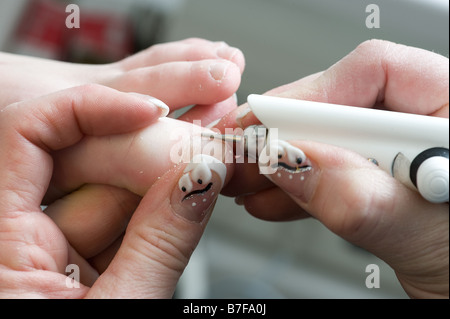 Foot therapist working on a girls nails Stock Photo