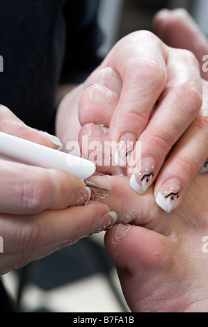 Foot therapist working on a mans feet Stock Photo