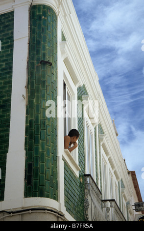 Boy in a window, Lagos, Portugal Stock Photo