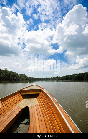 Boat on tour of Brunei river and Kampung Ayer water village in Bandar Seri Begawan, Brunei. Royal palace in far distance. Stock Photo