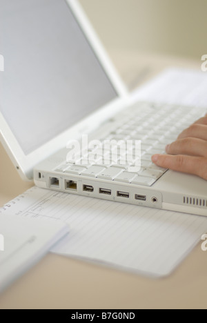 Person typing on a white laptop Stock Photo