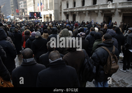 Spectators gather outside the New York Stock Exchange in New York to watch the inauguration of Barack Obama Stock Photo