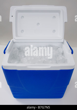 An open, blue cooler or cool-box  filled with only ice shot in a studio on a white background. Stock Photo