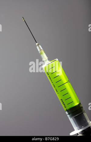 Hypodermic Syringe with Green Liquid Stock Photo
