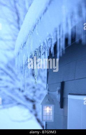 Close up of icicles hanging from gutter Stock Photo