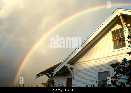 Rainbow over hawaiian house Stock Photo