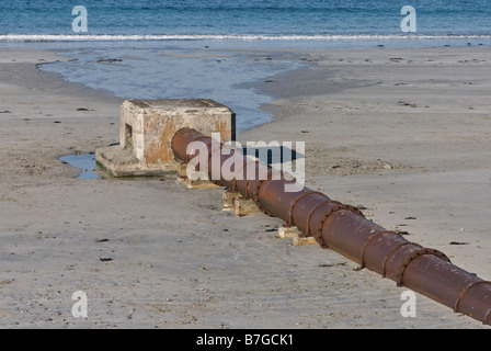 Surface water outfall pipe on sandy beach Stock Photo