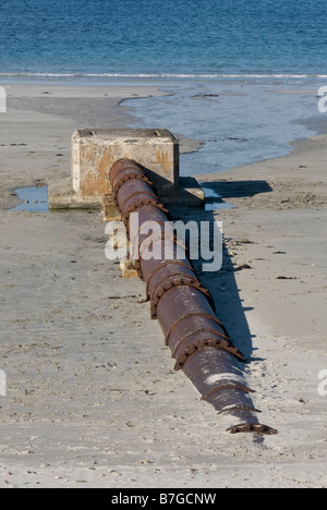 Surface water outfall pipe on sandy beach Stock Photo