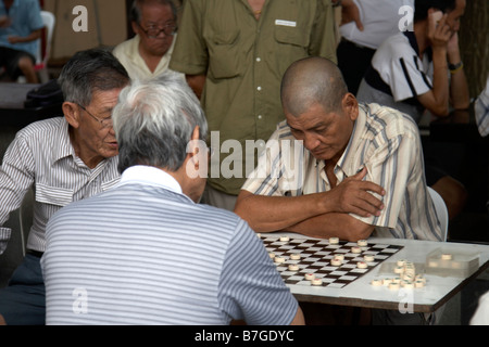 Men playing a board game in Chinatown, Singapore Stock Photo