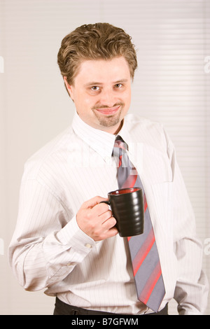 Young and confident businessman is having coffee Stock Photo