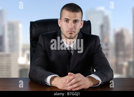 Businessman sitting at the desk Stock Photo