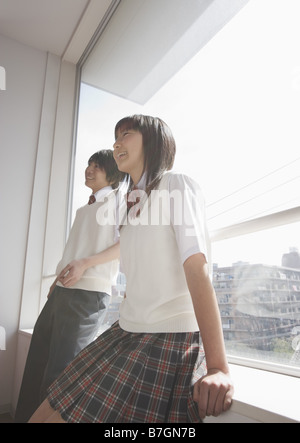 Teenagers talking in classroom Stock Photo