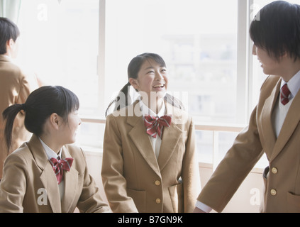 Teenagers talking in classroom Stock Photo