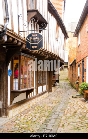 St John's Alley an Elizabethan lane of timber framed buildings housing a hat shop or milliners in Devizes Wiltshire England UK Stock Photo