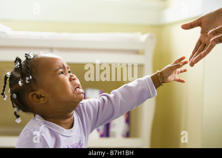 African girl crying and reaching upward Stock Photo