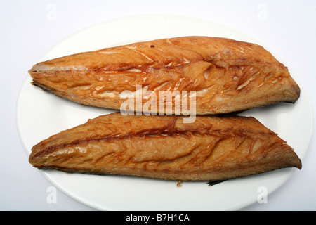Two smoked mackerel fillets on a plate with a white background Stock Photo