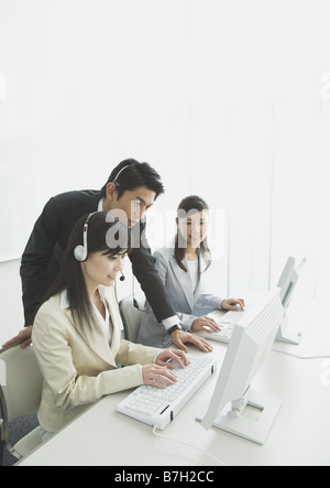 Operators, talking with a businessman, working in the office Stock Photo