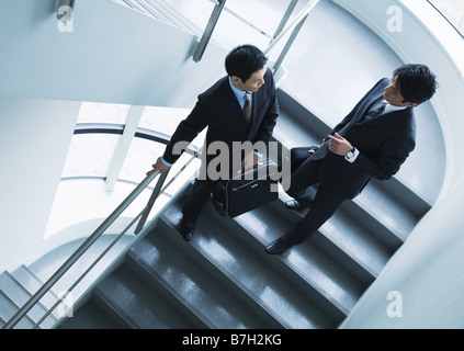 Businessmen in discussion on stairs Stock Photo