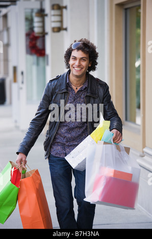 Middle Eastern man carrying shopping bags Stock Photo