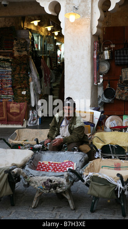 One of the many aged barrow boys who act as porters in Souq Waqif Doha Qatar No model release editorial use only Stock Photo