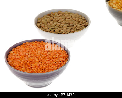 Assorted Bowls Of Dried Red Yellow And Green Lentils Isolated Against A White Background With No People And A Clipping Path Stock Photo