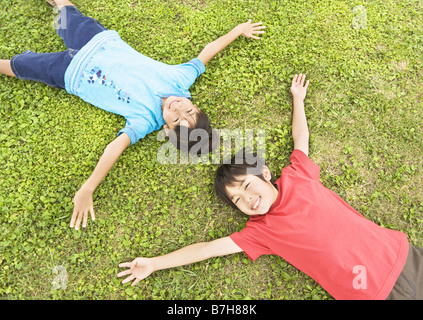 Children lying on the grass Stock Photo