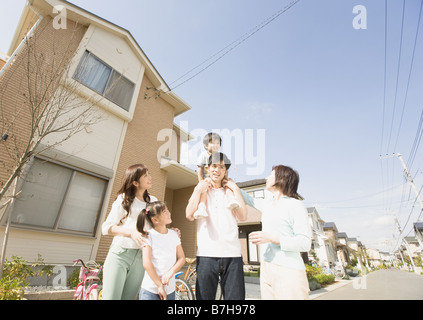 Father carrying son on his shoulder and family Stock Photo