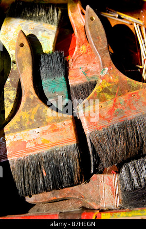 Close up of pile of heavily used paintbrushes drying in the sun. Stock Photo