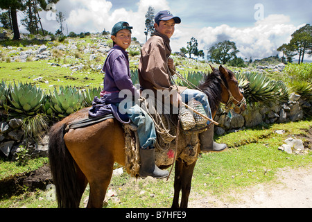 Two brothers mounted on a horse near San Nicolas Western Highlands Guatemala Stock Photo