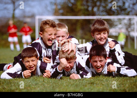 Children. Sport. Group of happy boys celebrating victory at end of Soccer game. Stock Photo