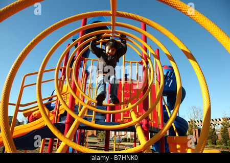 Adorable five year old boy playing at park in cold weather Stock Photo