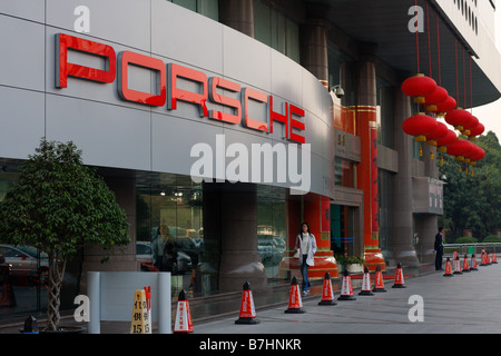 Porsche Dealership storefront with Chinese New Year Decorative Red Lanterns and Chinese Characters on sign Stock Photo