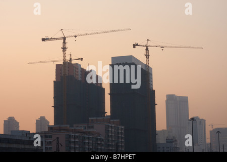 Chinese traffic as seen from overpass durring sunset with skyline and  counstruction in view. Stock Photo