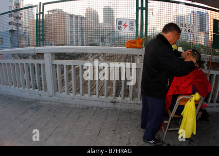 An unregulated self made street barber shop in Guangzhou China Stock Photo