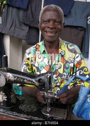 Portrait of tailor with sewing machine working on street of Kisangani in Democratic Republic of Congo Stock Photo